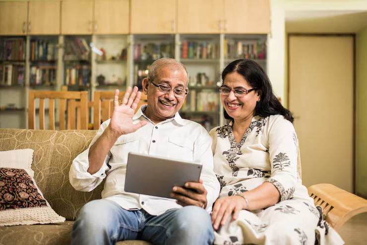 indian-asian-senior-couple-video-chatting-tablet-computer-while-sitting-couch-garden-home-selective-focus_466689-33571 (1)